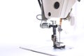 working area of a modern industrial sewing machine equipped with a compensating sewing foot for highspeed seaming of fabric border Royalty Free Stock Photo