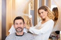 working as hairdresser cutting hair tips male customer Royalty Free Stock Photo