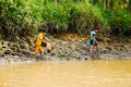 Working asian children in Vietnam by the mud`s river Mekong