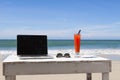 Working on the beach with laptop, freelancer traveling and remote work Royalty Free Stock Photo