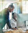 Working better together. two businesspeople working together at a computer in the office. Royalty Free Stock Photo