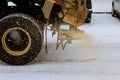 Big red snowplow sands carriageway during snowfall and ice Royalty Free Stock Photo