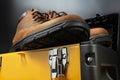 Working boots on yellow toolbox