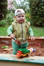 Working boy playing in a sandbox Royalty Free Stock Photo