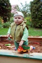 Working boy playing in a sandbox Royalty Free Stock Photo