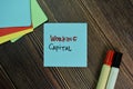 Working Capital write on sticky notes isolated on Wooden Table