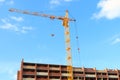 Working crane and red brick residential building Royalty Free Stock Photo