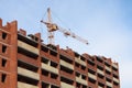 Working crane and red brick residential building Royalty Free Stock Photo