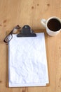 Working with crumpled paper,coffee cup, and pen on wooden table background Royalty Free Stock Photo