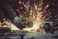 Working on cutting a metal tube with a sharp angle grinder with circular blade and generating sparks Royalty Free Stock Photo