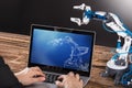 Working On Design Of Industrial Robot Arm On Laptop Royalty Free Stock Photo