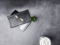 Working desk with coffee, glasses, cactus, notebook on concrete desk