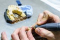 Working with a drill in a dental prosthesis Royalty Free Stock Photo