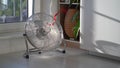 Electric fan with red wriggle ribbon designed to cool air and supply wind located near window