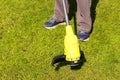 Working with an electric grass trimmer on the green lawn of the garden plot.