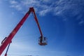 Working electrician working at height on hydraulic aerial platform against the blue sky. Royalty Free Stock Photo