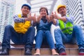 Working engineer.They are join hands mean teamwork  and spirit beside building background. Royalty Free Stock Photo