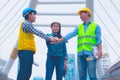 Working engineer.They are join hands mean teamwork and spirit beside building background Royalty Free Stock Photo