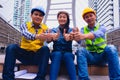 Working engineer.They are join hands mean teamwork  and spirit beside building background. Royalty Free Stock Photo