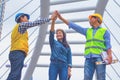 Working engineer.They are join hands mean teamwork and spirit beside building background. Royalty Free Stock Photo