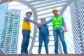 Working engineer.They are join hands  mean teamwork and spirit beside  building background. Royalty Free Stock Photo