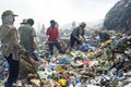 Working Filipino women on garbage dump, recycling