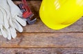 Working gloves, building helmet and glasses, tool equipment on wood table Royalty Free Stock Photo