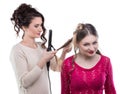 Working hairstylist curling client