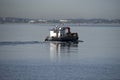 Working harbor vessel motors across Botany Bay