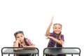 Working hard on their knowledge. Adorable small schoolchildren passing knowledge test at school desks. Knowledge and