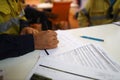 Working at heights permit book placing on the table, defocused construction site supervisor reviewing job hazard analysis