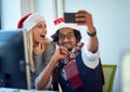 Working at holiday at office.Business people  work at Christmas and  take selfie in santa hat Royalty Free Stock Photo