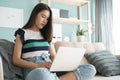 Working from home. beautiful of a young woman using computer laptop sitting on sofa in the living room at the house, asian girl Royalty Free Stock Photo