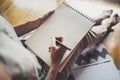 Working at home concept. Young business woman writing and taking notes while relax sitting in comfort chair at home Royalty Free Stock Photo