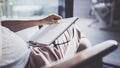 Working at home concept. Young business woman writing and taking notes while relax sitting in comfort chair at home Royalty Free Stock Photo