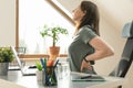 Working from home and exercise at home office. Beautiful woman stretching her back while sitting at workplace. Healthy living and Royalty Free Stock Photo