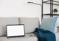 Working from home, laptop computer with blank empty white screen display monitor on sofa. Mock up, copy space. Royalty Free Stock Photo