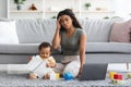 Stressed Black Mother Trying To Work At Home While Baby Distracting Her Royalty Free Stock Photo