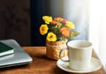 Working from home set up. Laptop computer and coffee cup on a table by the window. Royalty Free Stock Photo