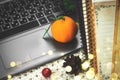 Working at home winter cozy time and holidays still life with citrus tangerines composition, laptop, copy space, bokeh