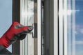 A working installer checks the window frame