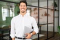 Working with joy. Smiling cheerful hispanic business man wearing formal white shirt standing with laptop Royalty Free Stock Photo