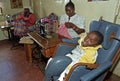 Working Kenyan woman, disabled child, Nairobi Royalty Free Stock Photo