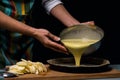 Working in the kitchen. Detail of hands pouring mash prepared in the dough. Cook apple pie.Culinary ingredients. fruit cake. Royalty Free Stock Photo