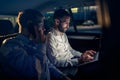 Working on laptop in back seat of car at night Royalty Free Stock Photo