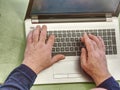Working on laptop close up of hands of old man Royalty Free Stock Photo