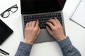 Working on laptop. Man`s hands working on computer. Bigness concept