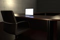 Working late concept representation with an empty conference room and a laptop