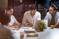 Working late, interracial asian business team brainstorm idea meeting Royalty Free Stock Photo