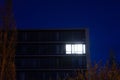 Working late: single illuminated office at night